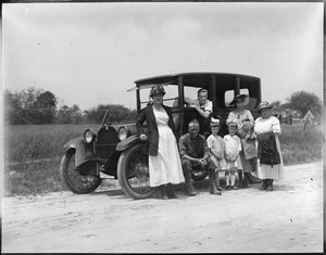 Family poses with auto