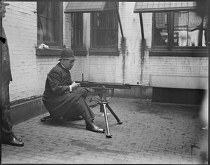 Officer Fox of Pemberton Sq. Station mans one of six machine guns given to Boston Police in case of riots from the declaration of war against Germany