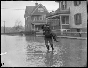 Winthrop: father carries daughter across flooded street so she can go to work. Shirley St. at Cutler St.