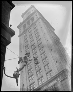 Boston Custom House from McKinley Square (State St. block). Chas C. Hutchinson Co. hangs famous old 'ad' - Mercury - an early post office symbol on State St., later symbol for nautical instrument co. Original is at old State House.