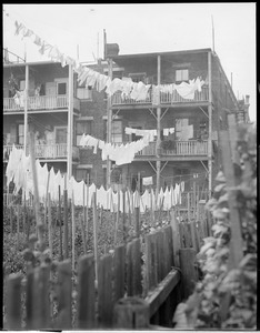 Laundry on lines behind triple deckers