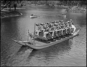 Members of the Women's Naval Reserve ride on swan boats in the Public Garden