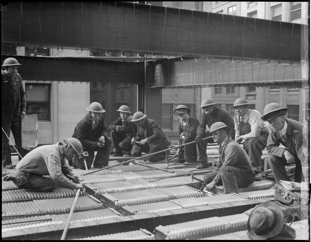 Workers building new post office wear WWI helmets to protect them from fatal rivets