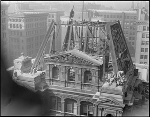 U.S. Post Office being torn down, Boston Mass. Famous old post office building being torn down, showing the last of the two big French's statues being removed.