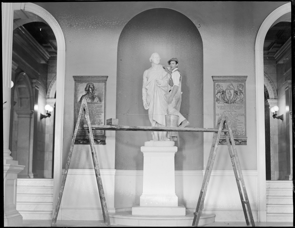 Robert J. Guthrie cleaning the George Washington statue in the State House for the bicentennial of Washington's birth