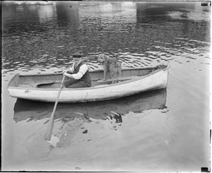 Man and dog in rowboat near Warren Ave. Bridge