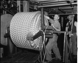Charlestown Navy Yard/rope making; James J. Lee binding coil of a 7" Hauser that has just been completed in ropewalk