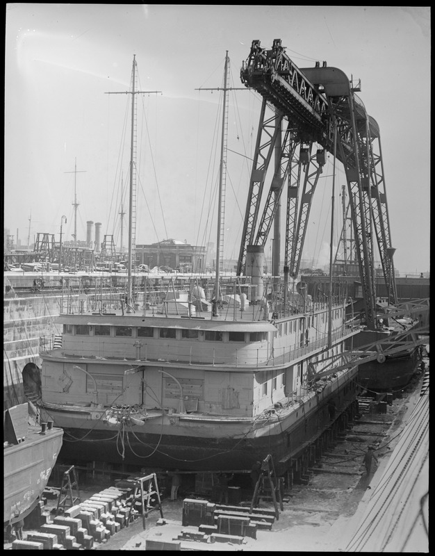 Navy Yard showing huge crane Hercules looming over a torpedo testing barge in drydock