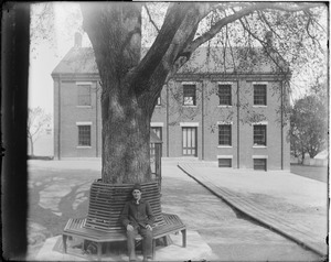 Man seated in front of house