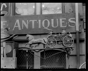 Horse-drawn fire engine advertises antiques