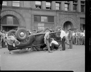 Overturned auto in front of American Mutual Building