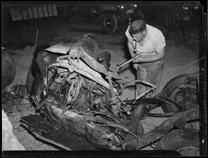 Man inspects wreck