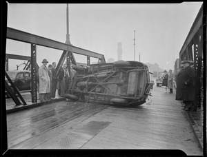 Car overturns on Dover St. bridge.