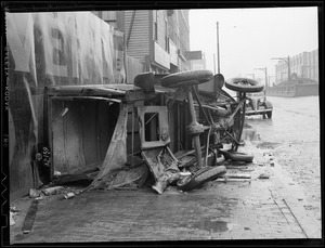 Overturned auto on sidewalk