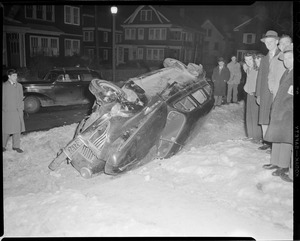 Car goes over on snowy streets