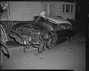 Wrecked auto on sidewalk