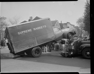 Supreme Markets delivery truck rolls over auto