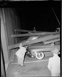 Sign falls on car