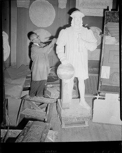 Artist working on statue of Columbus