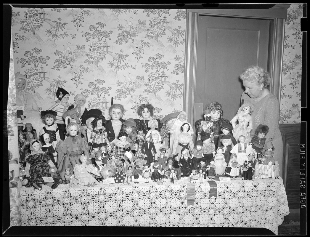 Woman with prize winning doll collection