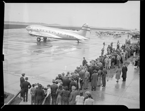 Crowd at airport with TWA passenger plane