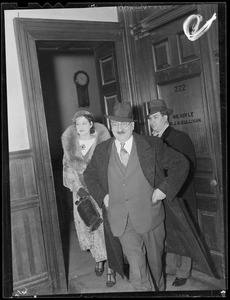 Two men and a woman leave office, possibly the D. A.