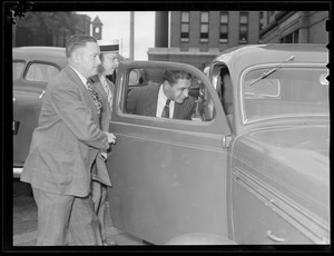 Parolee Raymond Patriarca, arrested in hold up, court officer James E. Desmond in straw hat
