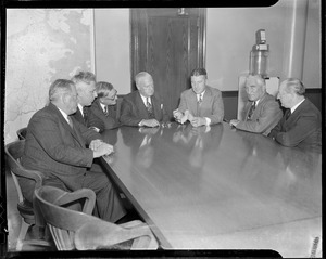 Men in conference room examine cast of murder victim Grayce Asquith's foot