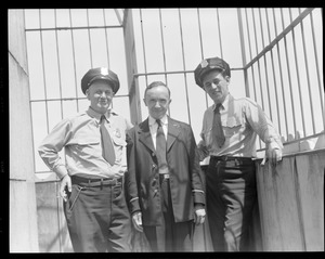 Three lawmen pose in jail cell
