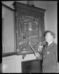 Lowell police - St. John H Graham of Lowell police standing beside some very rare weapons taken from criminals dating 1885