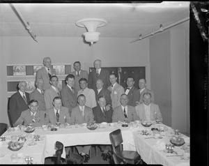 Men pose at dinner