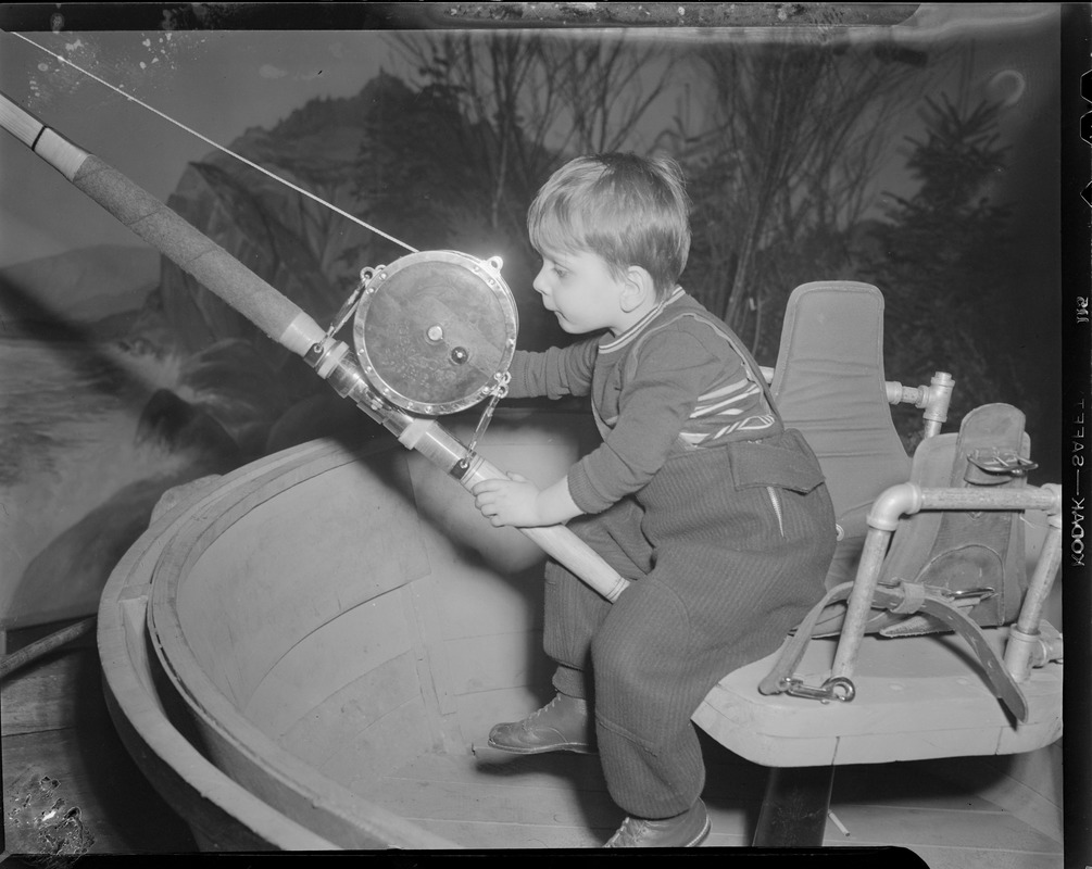 Boy tries out fishing gear at sportsman's show