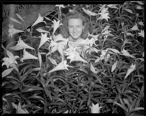 Woman poses with Easter lilies