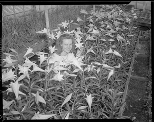 Woman poses with Easter lilies