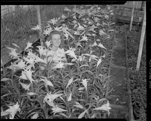 Woman poses with Easter lilies