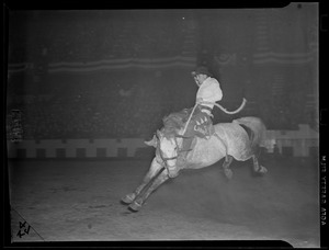 Larry riding bucking bronco, W.T. Johnson Rodeo
