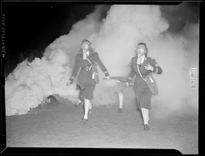 2 women doing a fire drill with masks on