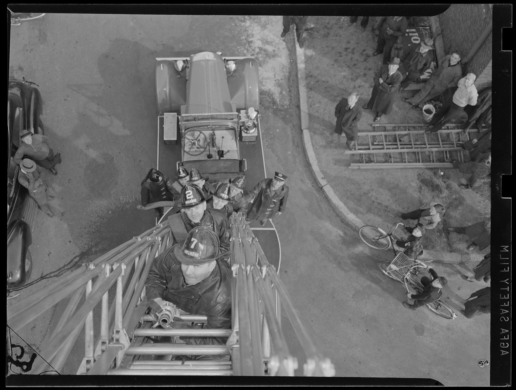Unusual view of firemen on ladder
