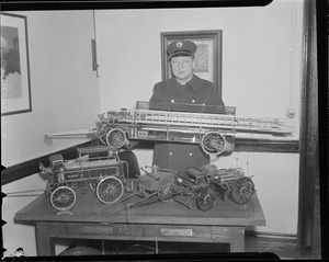 Fireman with models of old fashioned engines