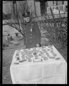 Fireman standing with array of paper weights