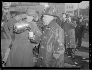 Red Cross worker pours coffee for fire man, Maverick Square Fire, East Boston