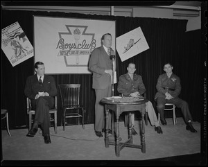 Frederic C. Church, Jr., speaks at induction of Boys' Club of Boston members into the Victory Volunteers while Boston Mayor Maurice Tobin, Col. George A. Ford, and Pfc. Hy Rosen watch at Jordan Marsh Co. Auditorium