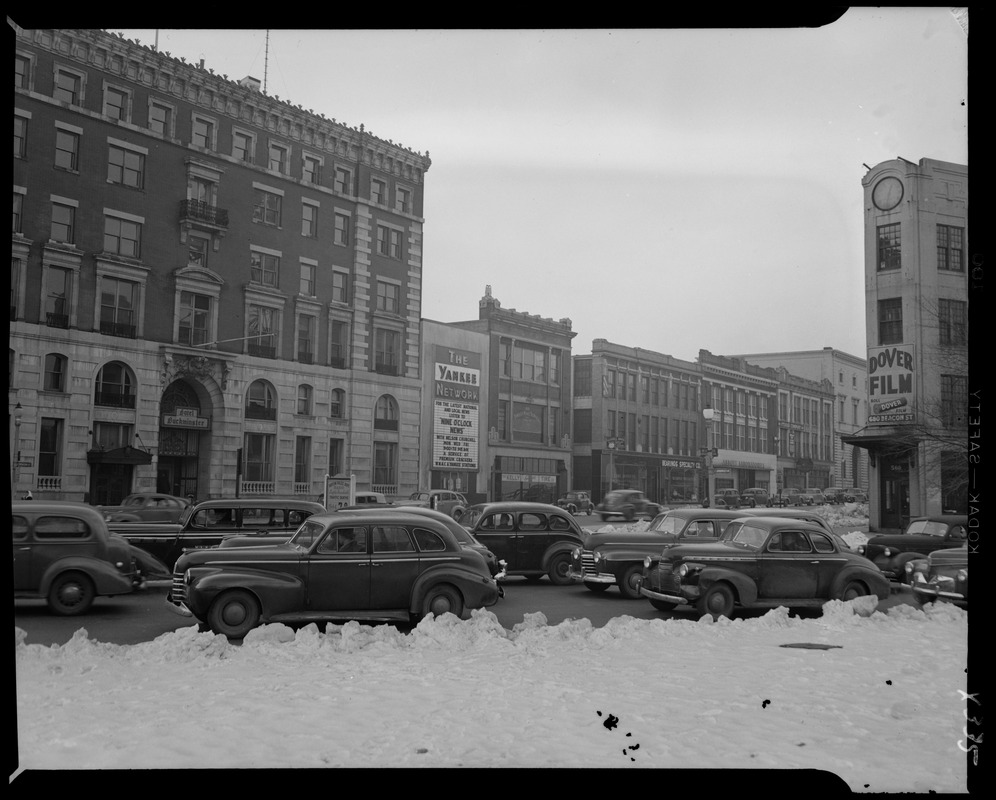 Street scene with Yankee Network letter board sign advertising Nine O'Clock News with Nelson Churchill on WNAC sponsored by Premium Crackers