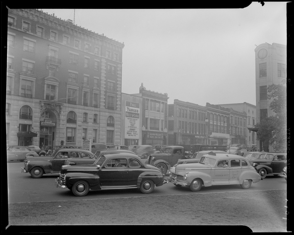 Street scene with Yankee Network letter board sign advertising Tello-Test on WNAC sponsored by Jenney Gasoline Dealers