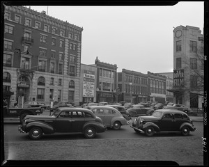 Street scene with Yankee Network letter board sign advertising Bill's Scrapbook on WNAC sponsored by Miss Cynthia and Cynthia Sweets Chocolates