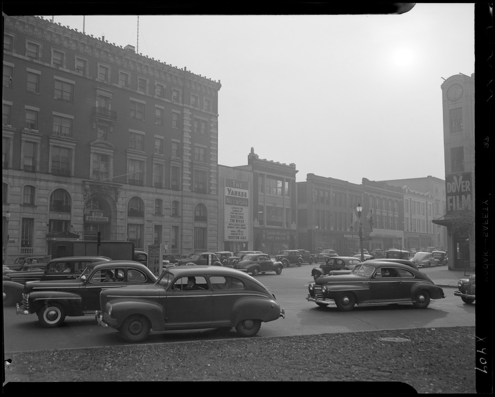 Street scene with Yankee Network letter board sign advertising Quizzing the Wives on WNAC sponsored by Boston Gas