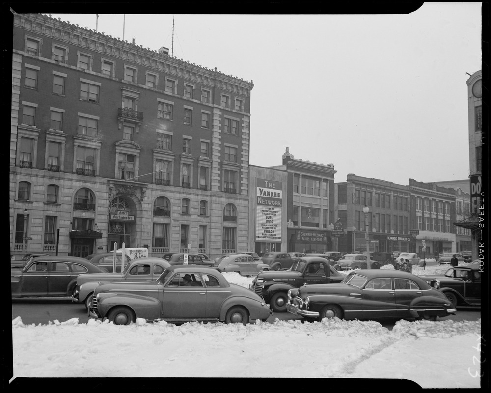 Street scene with Yankee Network letter board sign advertising Burl Ives on WNAC sponsored by Philco Radio Dealers