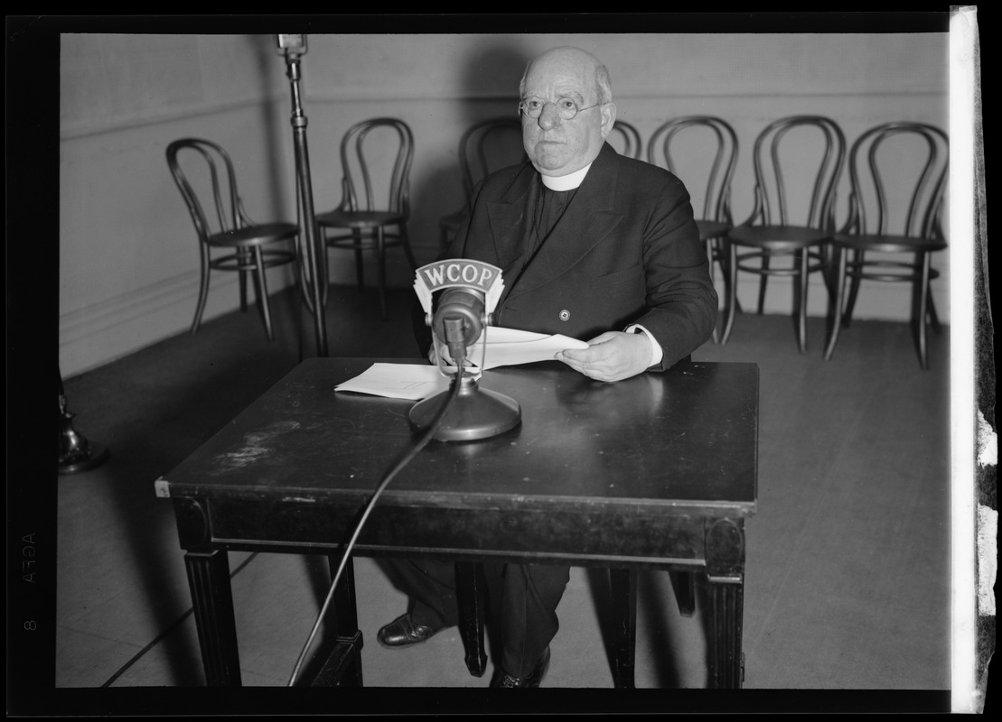 Priest sitting at WCOP microphone