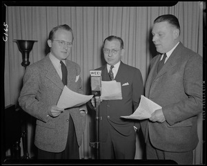 Three unidentified men at WEEI microphone
