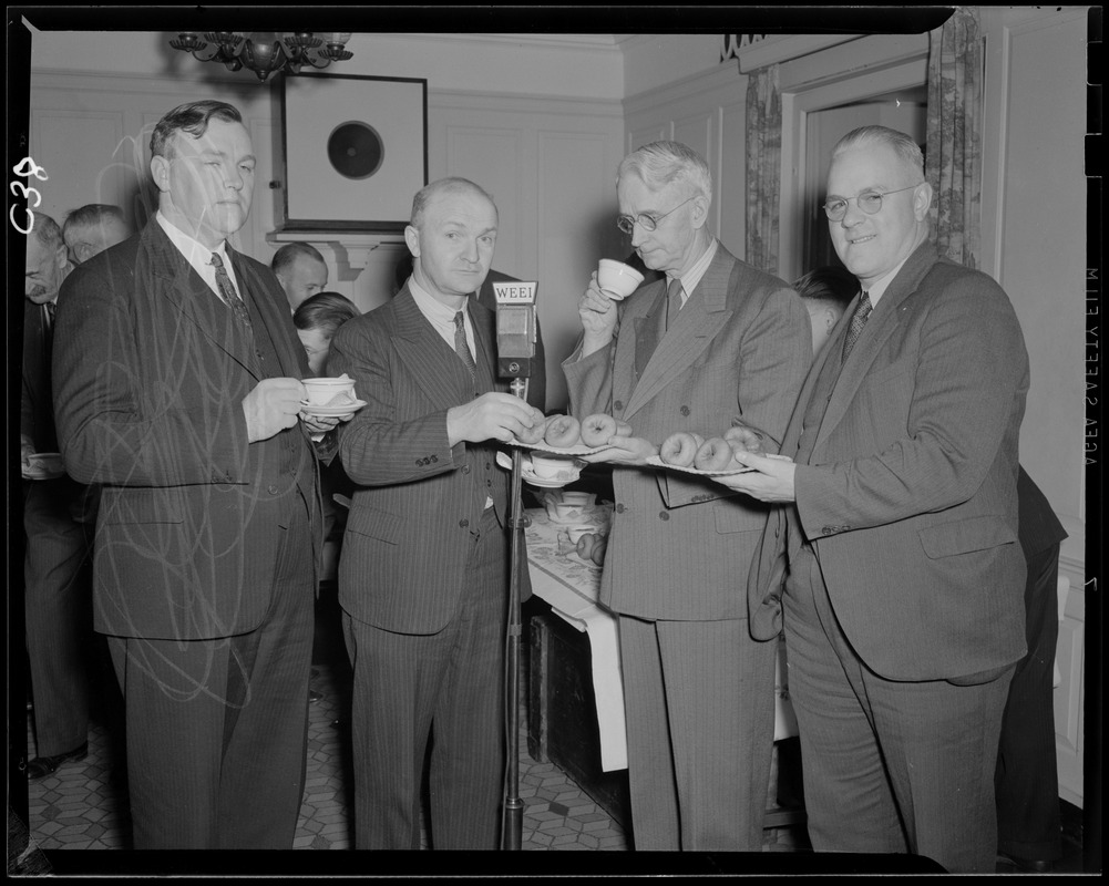 Group of unidentified men at WEEI microphone